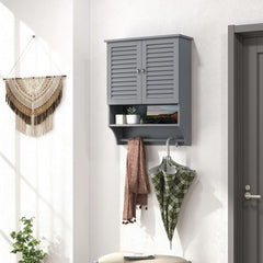 Grey wall cabinet mounted on a wall in a hallway with an umbrella and scarf hanging