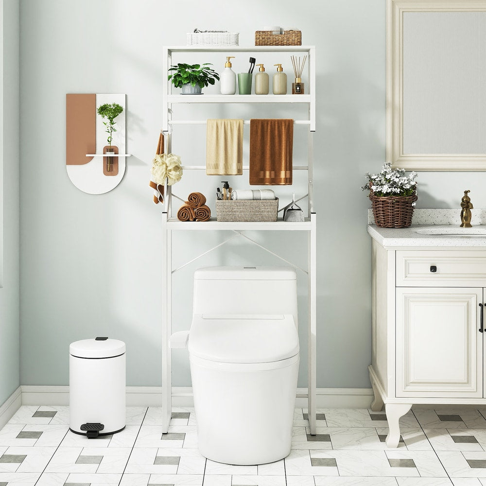 The white metal shelving unit positioned behind a toilet in a bright room with tiled floors