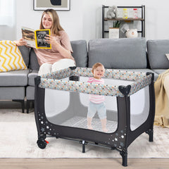 The baby playpen in a living room with a toddler standing inside on the lower base level