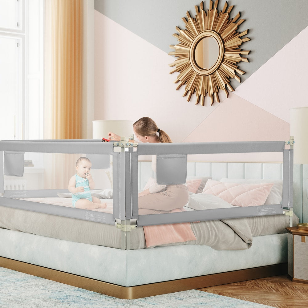 The bed rails installed around a double bed with a mother and baby sitting inside