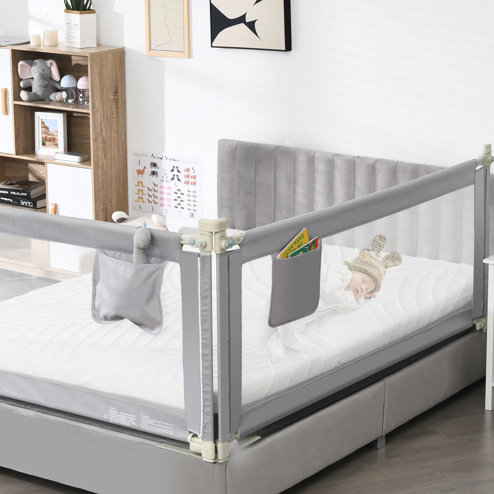 The bed rails fitted to a child's bed with a sleeping baby inside the enclosure