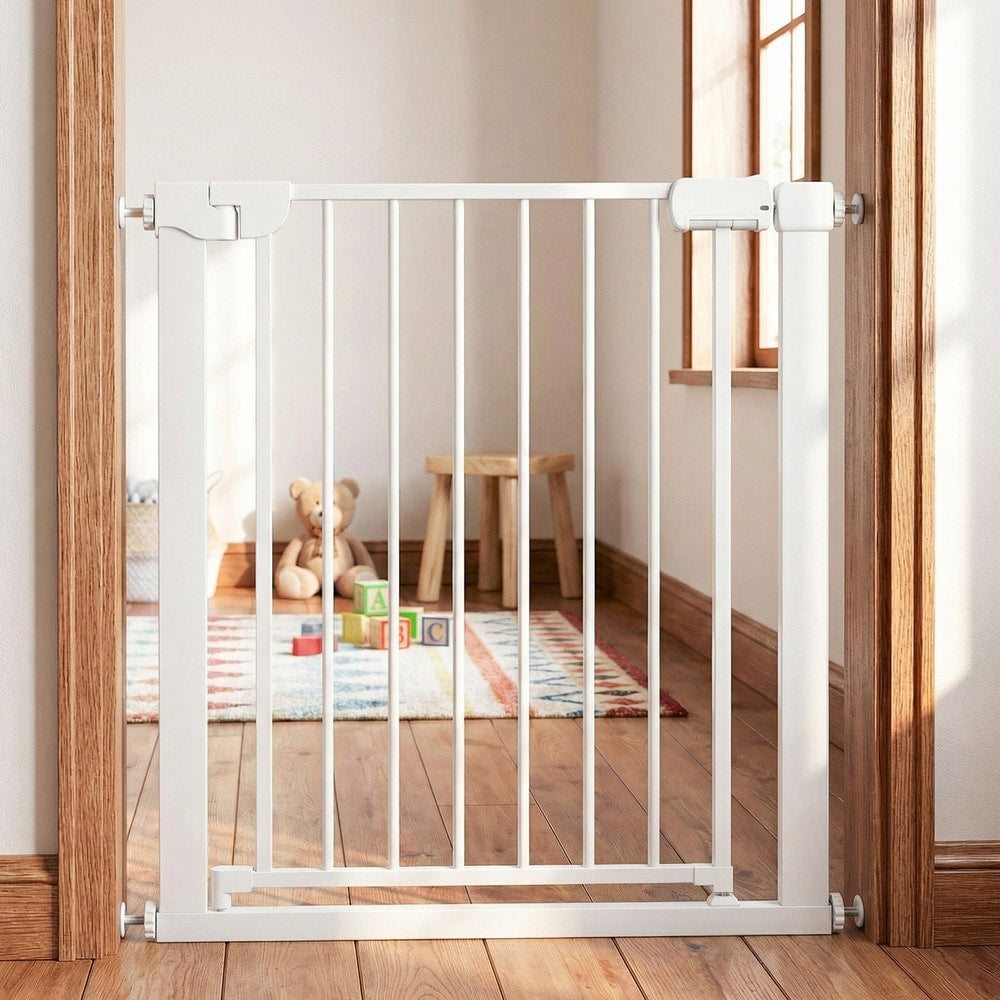 The pet gate installed in a doorway with a wooden floor and a childs play area in the background