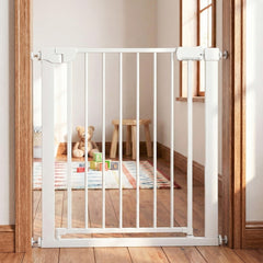 The pet gate installed in a doorway with a wooden floor and a childs play area in the background