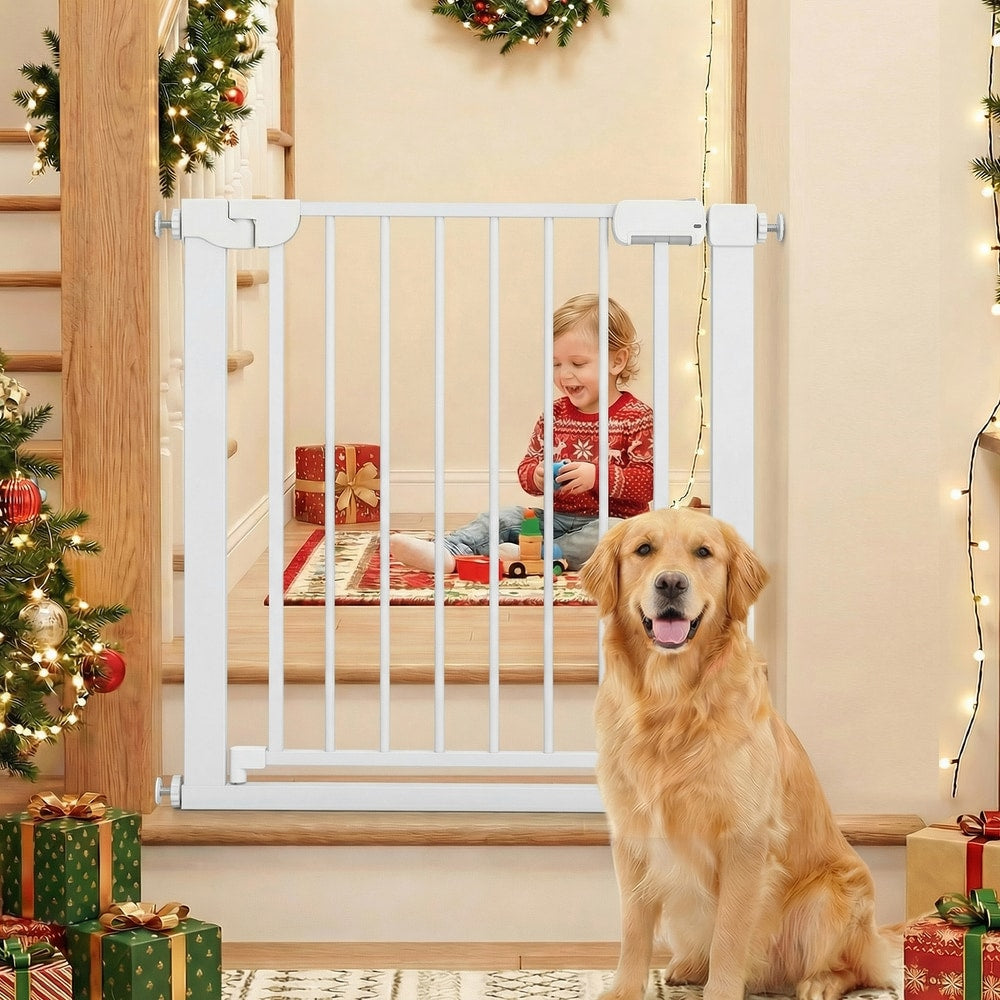 The pet gate placed at the bottom of stairs with a golden retriever sitting in front of it