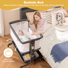 A mother and baby in bed next to the grey bassinet bedside sleeper, highlighting bedside bed use