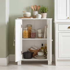 White kitchen cabinet with double doors open, filled with kitchenware and food items