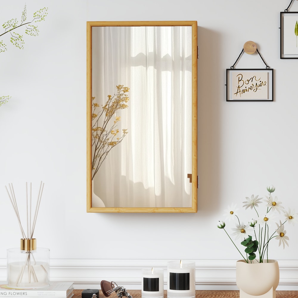 The wall cabinet mounted on a white wall with a closed mirror door reflecting the room
