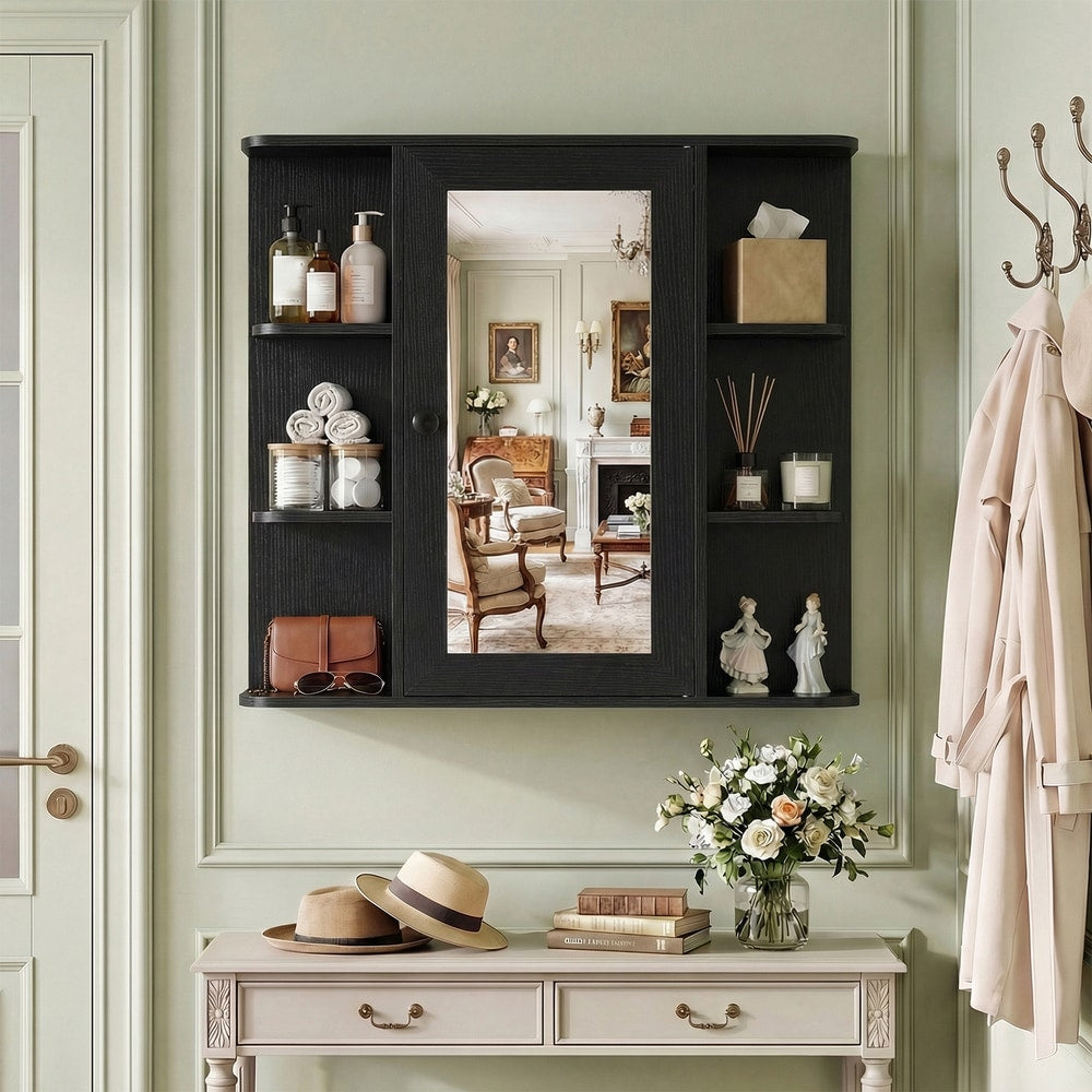 The black wall cabinet with mirror mounted on a wall in a hallway, styled with hats and a vase