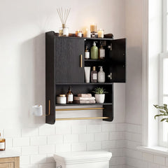 The wall cabinet with one door open showing internal storage and hanging towels below