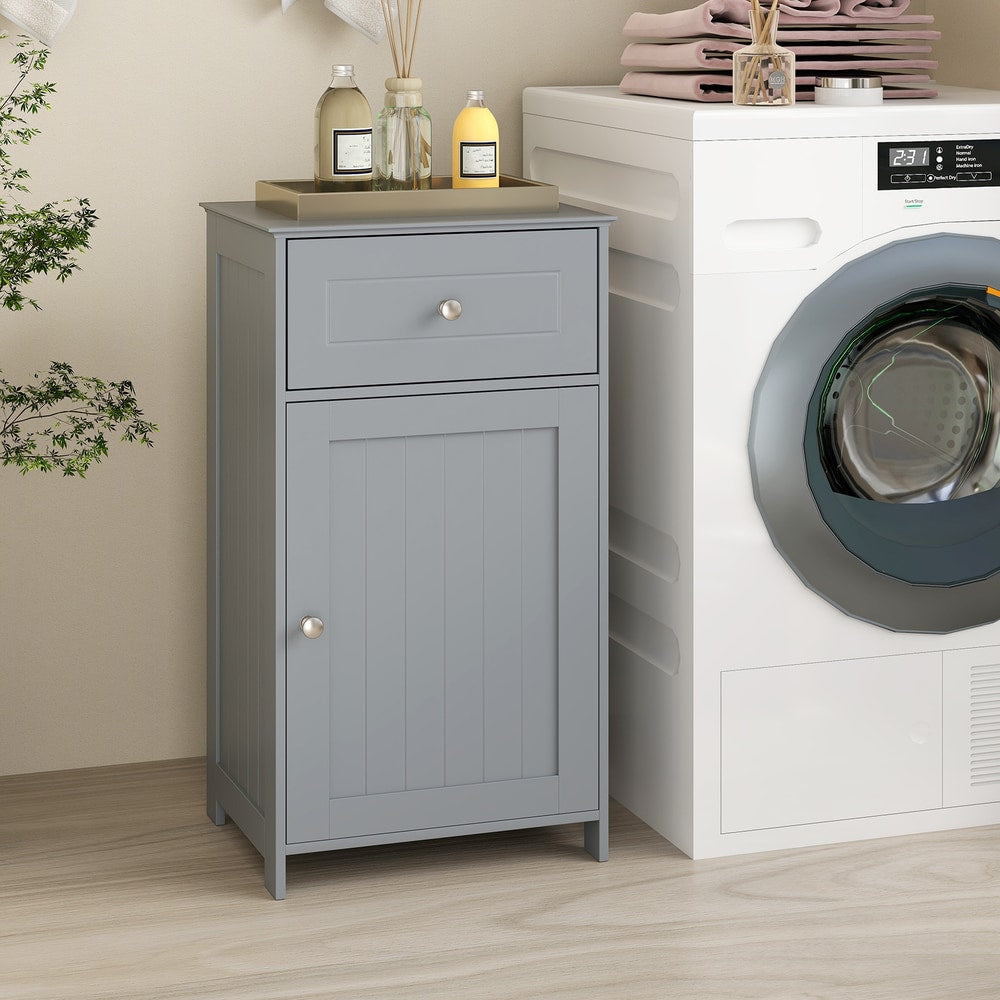 The floor cabinet standing next to a white washing machine in a neutral bathroom setting