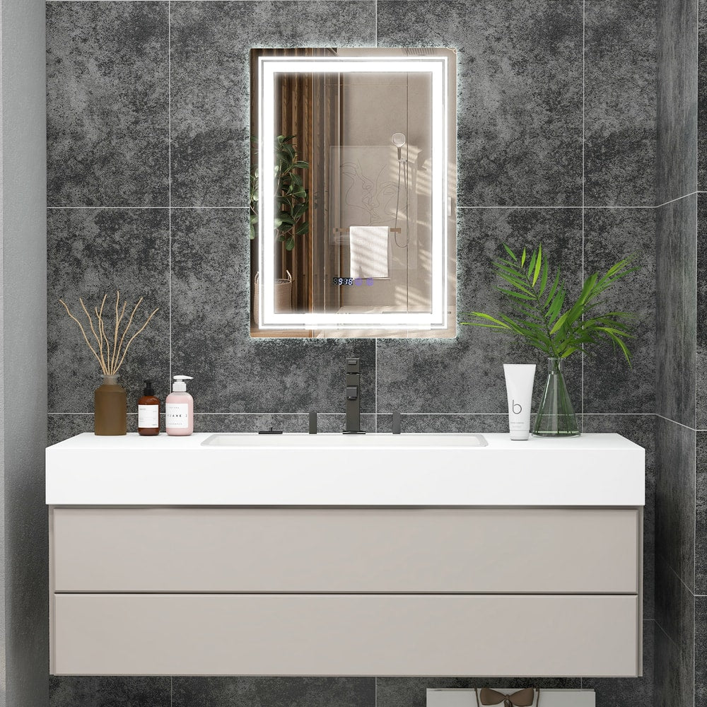 The LED vanity mirror with illuminated border above a bathroom sink and vanity unit