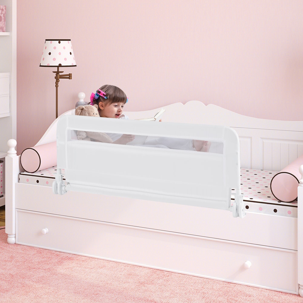 The bed rail installed on a white bed with a child sitting and reading in the bedroom