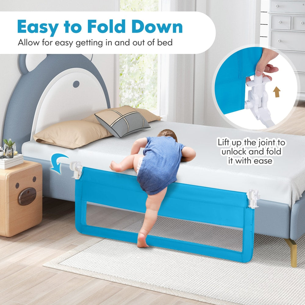 A baby climbs over the blue bed rail guard which is shown in a folded down position