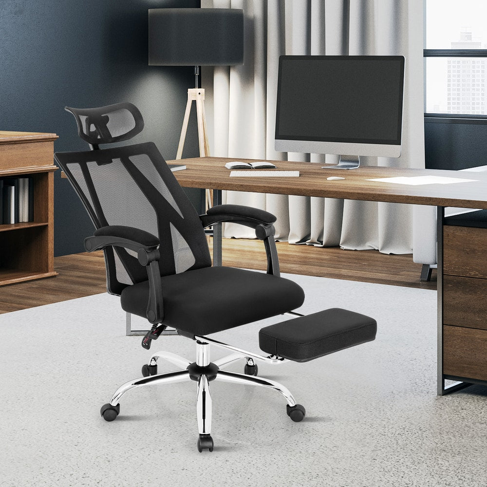 The office chair is shown from the side with the footrest extended