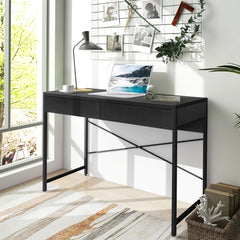 The black wooden study desk with two drawers in a bright room
