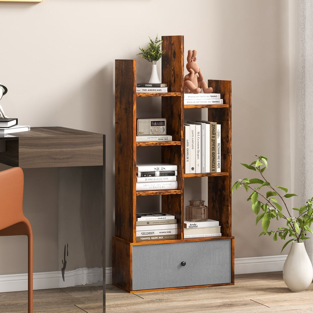 The wooden bookcase with a fabric drawer, filled with books and decorative items in a study