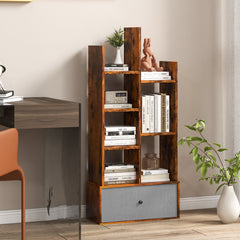 The wooden bookcase with a fabric drawer, filled with books and decorative items in a study