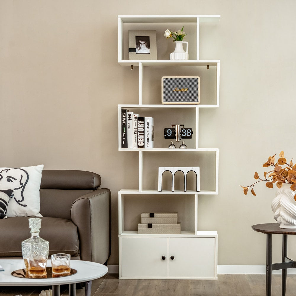 The white bookcase with cabinet in a lounge area with a sofa and coffee table