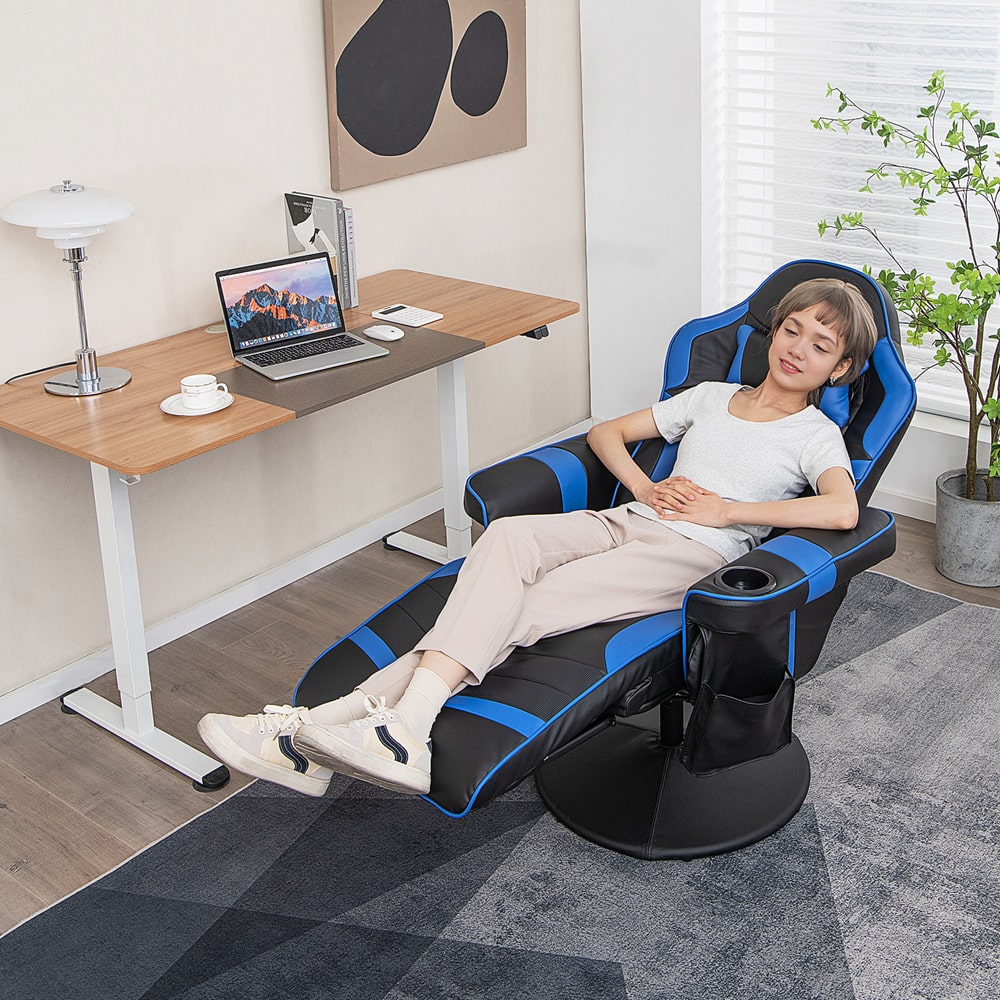 The gaming chair reclined with a person sitting in it while working at a desk