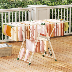The laundry rack holding various towels and socks on a wooden balcony deck