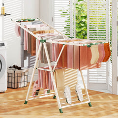The drying rack filled with laundry inside a bright room next to a window