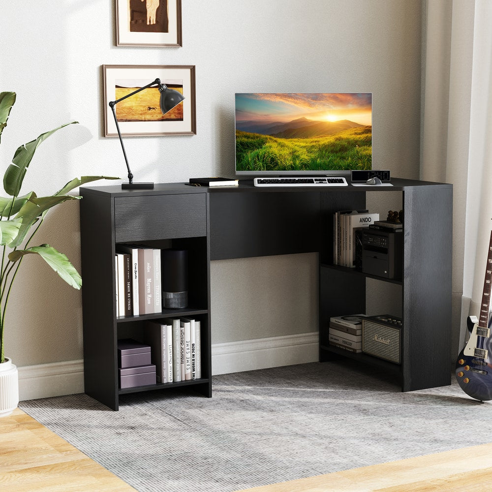 The black computer desk with storage, shown from the side with a computer and plant