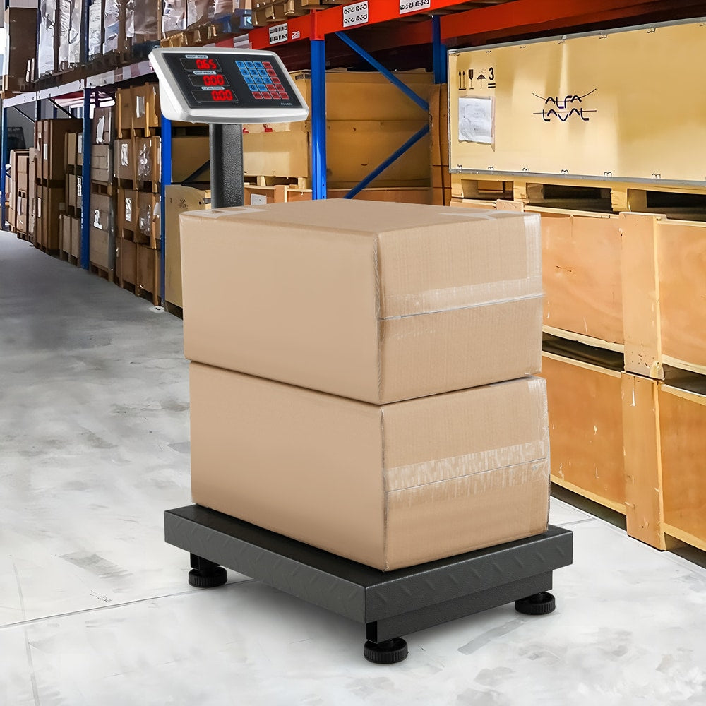 The digital platform scale with two cardboard boxes stacked on its weighing plate in a warehouse