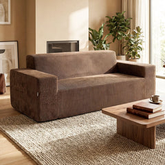 The brown corduroy sofa placed in a modern living room with a wooden coffee table