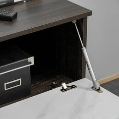 The entertainment unit cabinet door is held open by a metal gas strut mechanism for easy access
