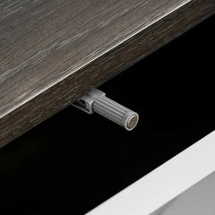 The entertainment unit uses a push-to-open magnetic latch mechanism for the cabinet door