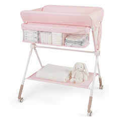 Pink changing table with storage pockets full of nappies and a folded towel
