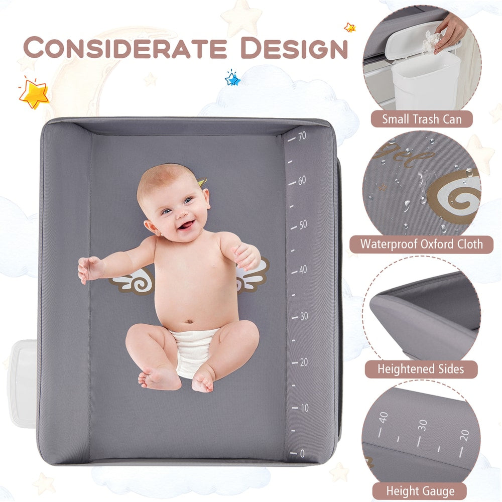 Close up of the grey changing table with a baby and features labelled