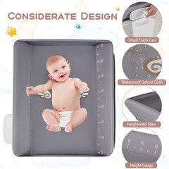 Close up of the grey changing table with a baby and features labelled