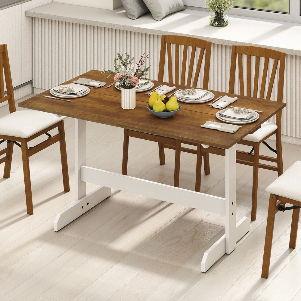 The dining table set up with four chairs in a bright room with a window