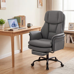 The office chair placed in a home office setting next to a wooden desk with a laptop