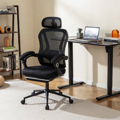 Black mesh office chair in a modern home office setting next to a desk