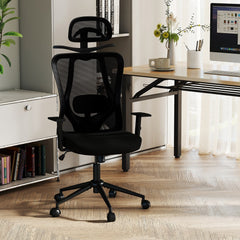 The office chair placed on a wooden floor next to a white storage unit and a desk