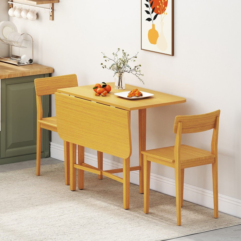 The dining table set up for two people with chairs in a kitchen setting