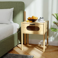 A farmhouse bedside table nightstand next to a bed