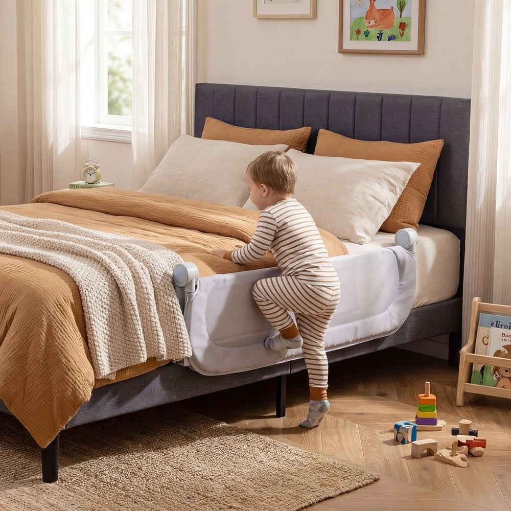 A toddler climbing over the bed rail onto a bed