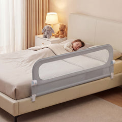 The bed rail attached to a bed with a child sleeping safely inside