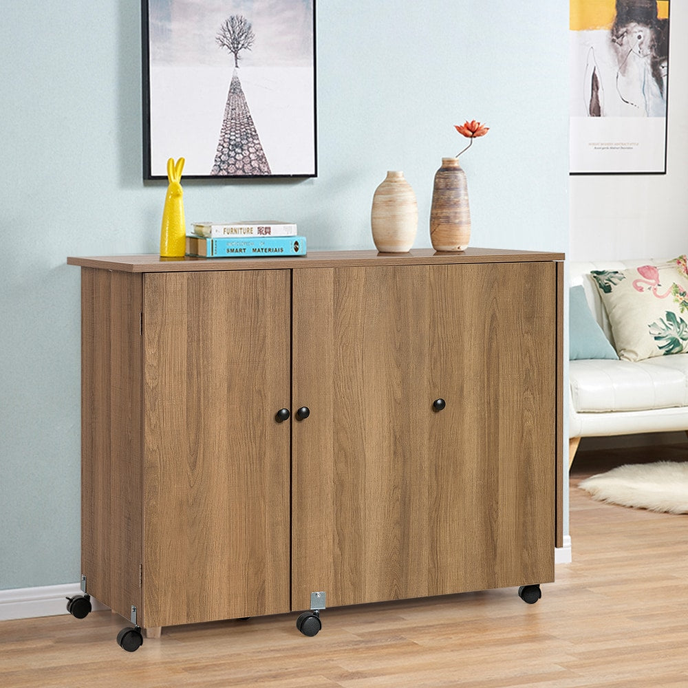 The sewing table closed, showing two wooden doors and lockable casters