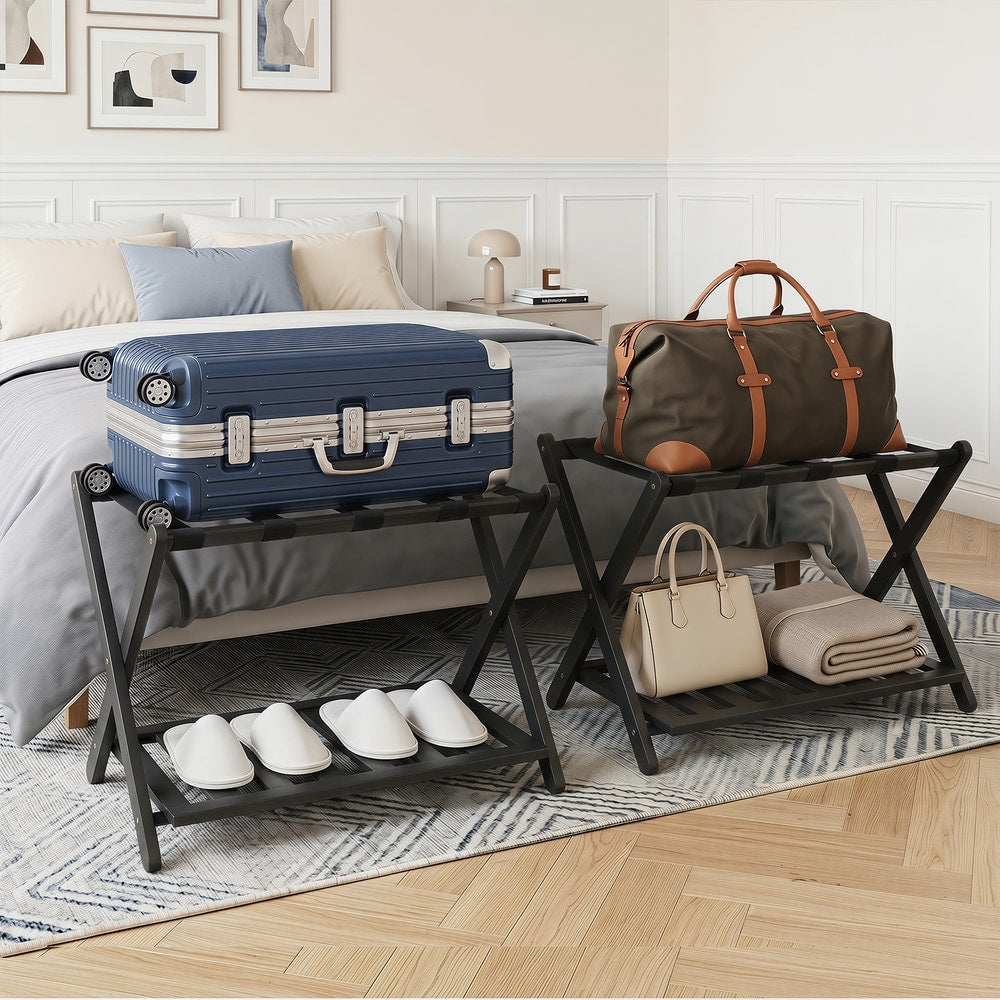 Two black luggage racks holding suitcases and bags in a bedroom setting