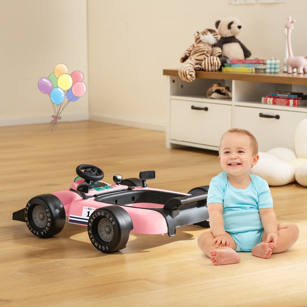 The baby walker converted into a floor toy with a happy child sitting beside it in a living room