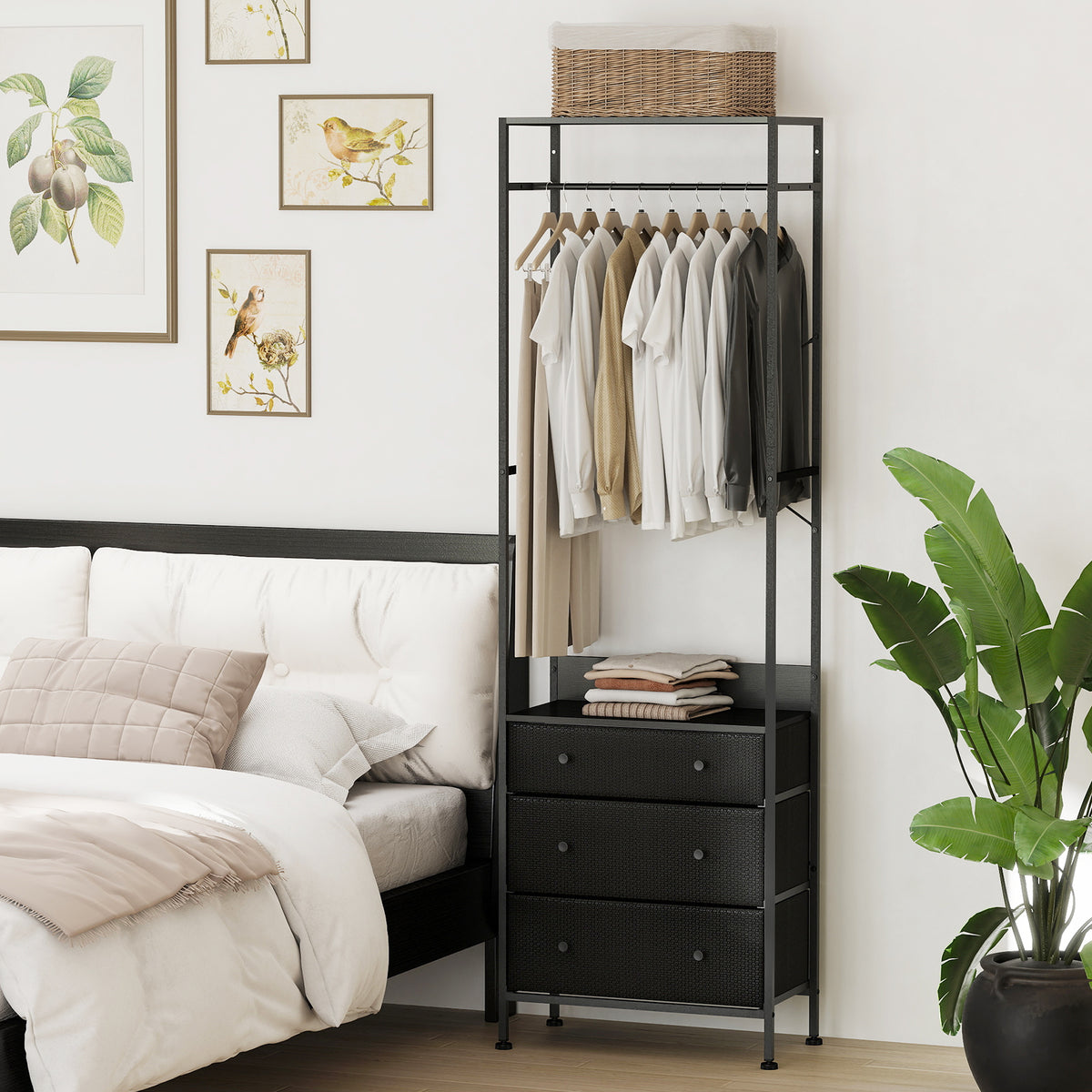The dresser and chest placed in a bedroom next to a bed with clothes hanging on the top rail