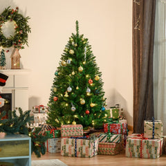 The artificial Christmas tree decorated with baubles and presents underneath in a cosy room setting
