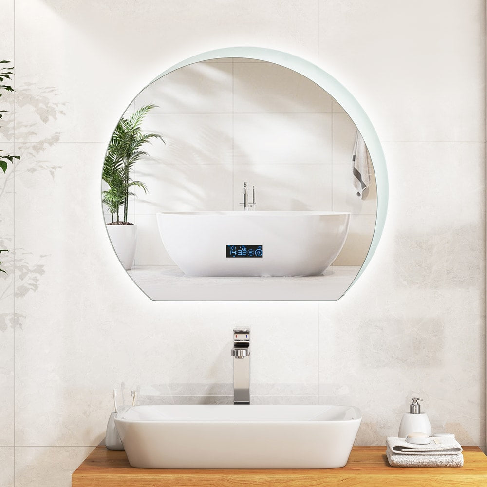 The bathroom mirror mounted above a white sink in a bright tiled room