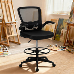Black mesh office chair with footrest ring in an artist's studio