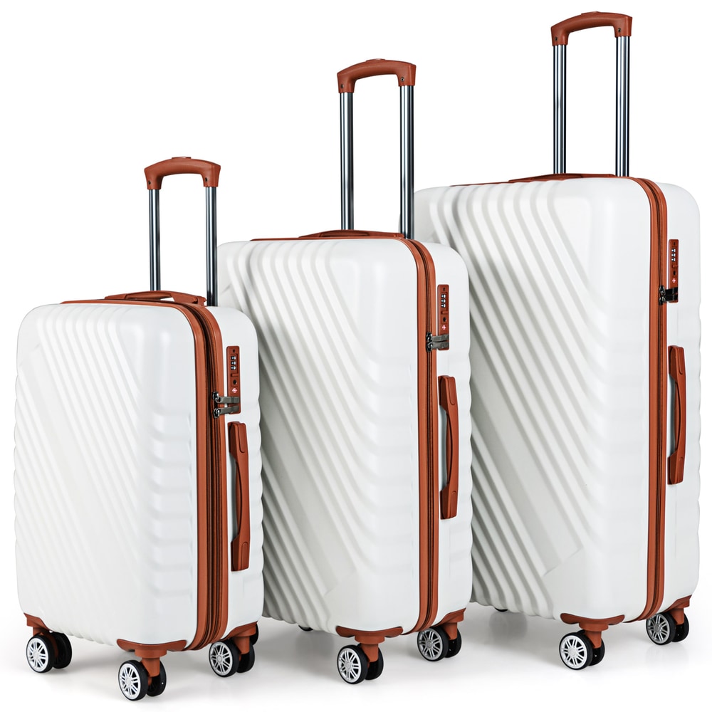 Three white suitcases of different sizes arranged together
