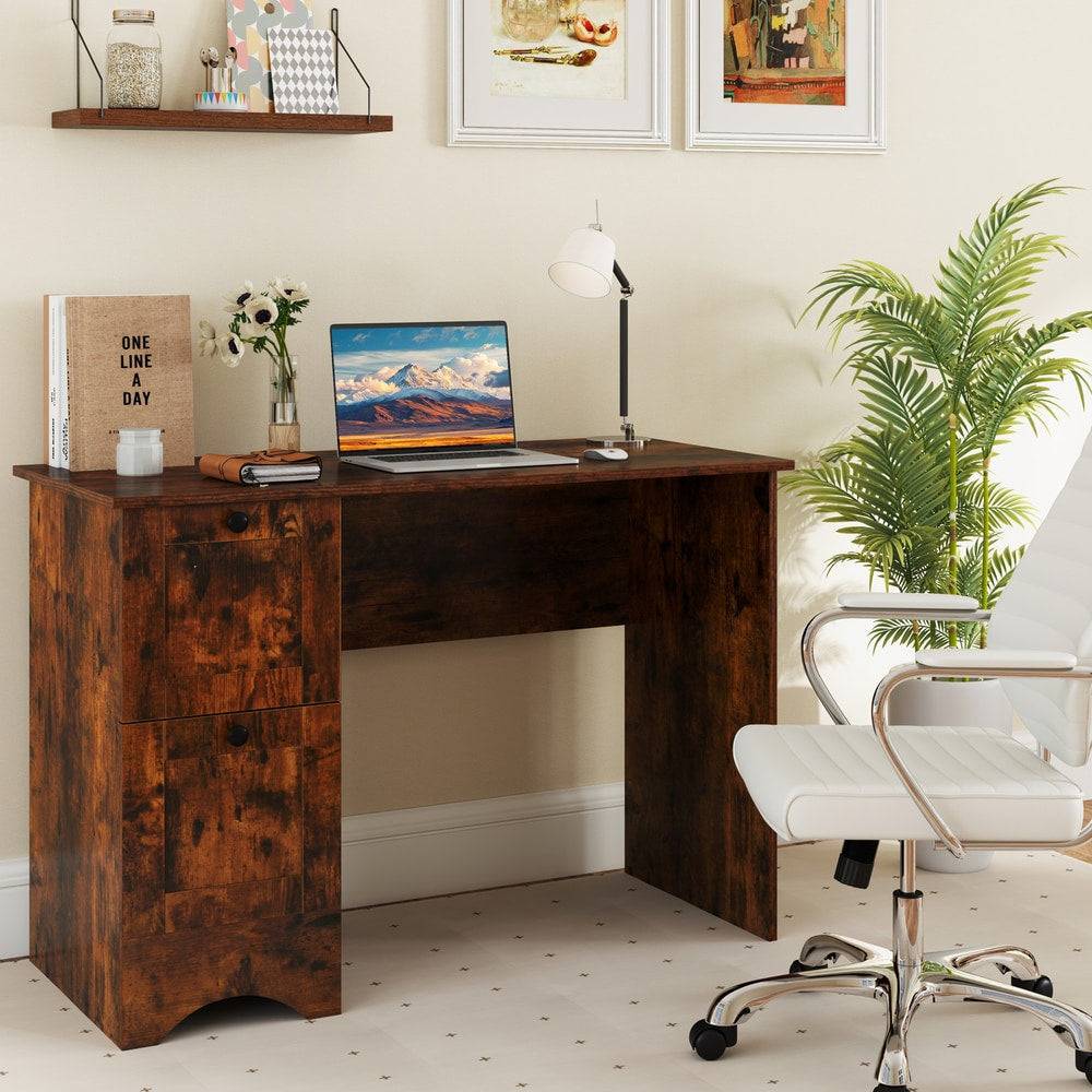 The office desk set up in a room with a laptop and chair, showing its use as a home workspace